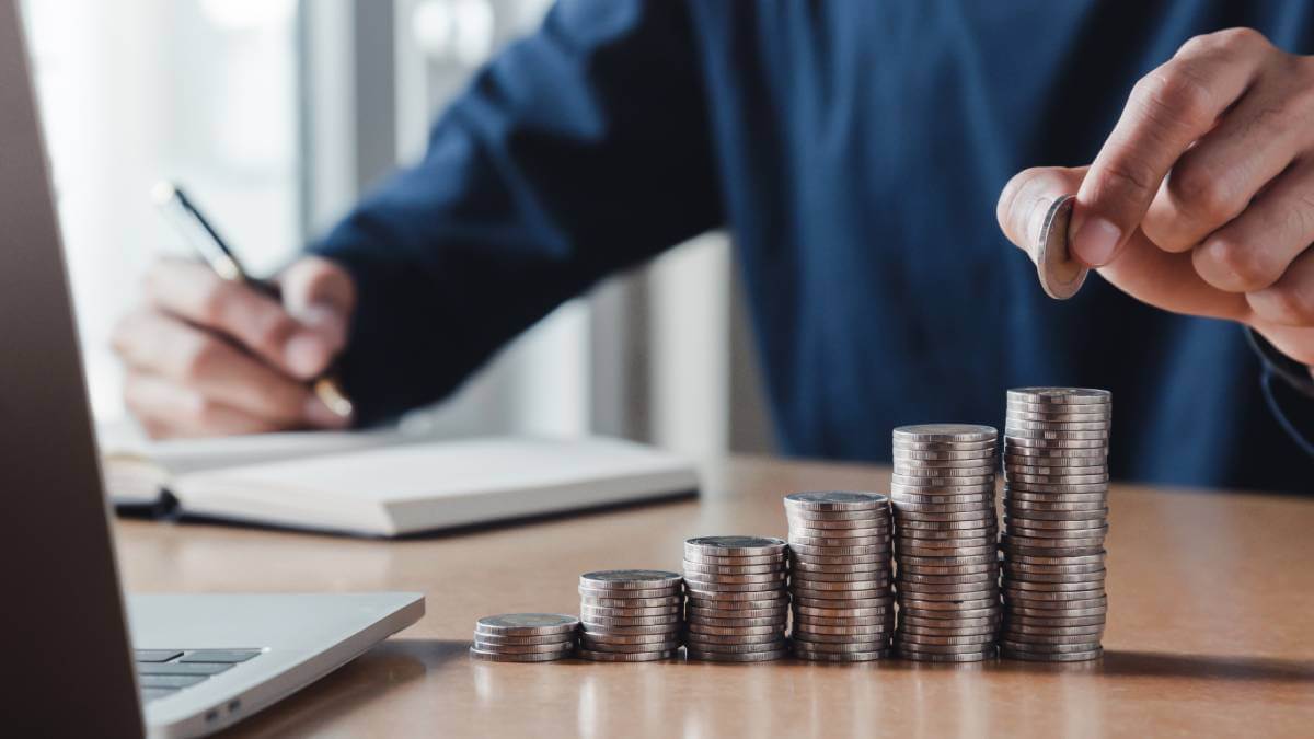 Man counting coins on a table